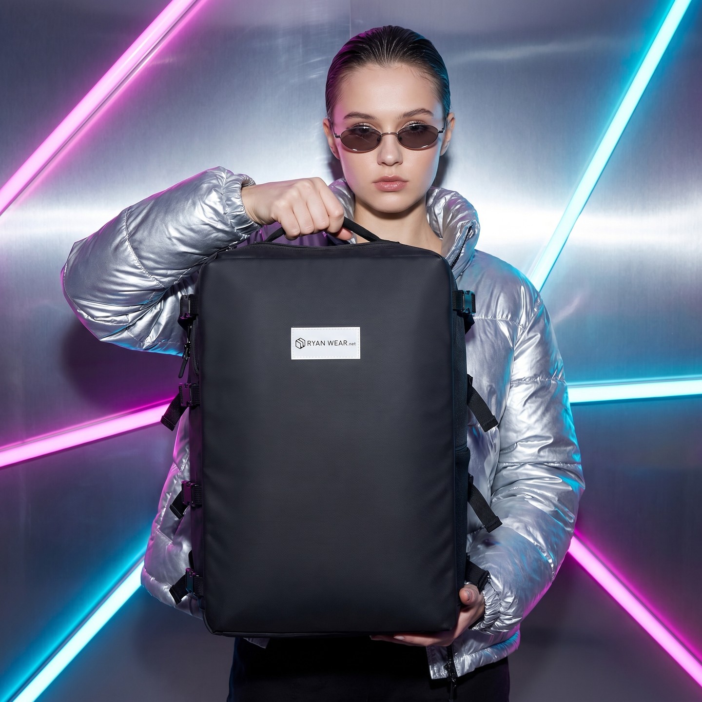 Main character energy, gate-side. ✨ Silver puffer, dark shades, and one black carry-on quietly holding the whole trip. B
